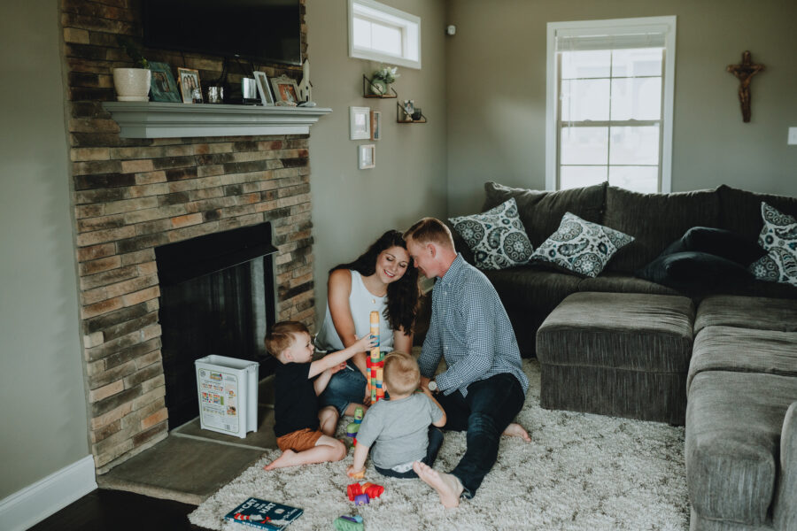 Family of four playing in their living room | Nashville Baby Guide